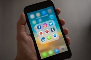 Person using social media on cell phone.