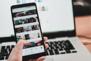 Person scrolling through their photos on cell phone.