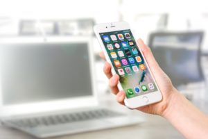 Person looking at cell phone apps.